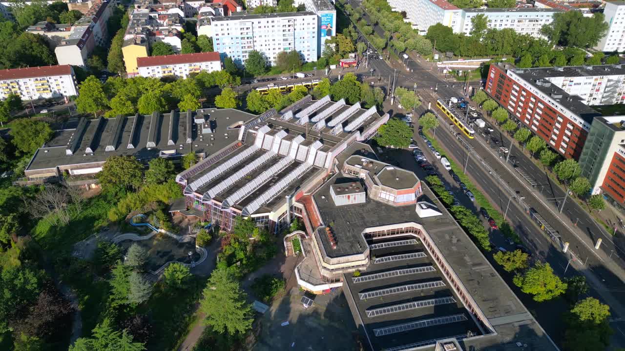 Sez and Volkspark Friedrichshain in Berlin, showcasing its lush greenery, a passing tram on a sunny day. speed ramp hyper motion time lapse Lovely aerial view flight panorama orbit drone