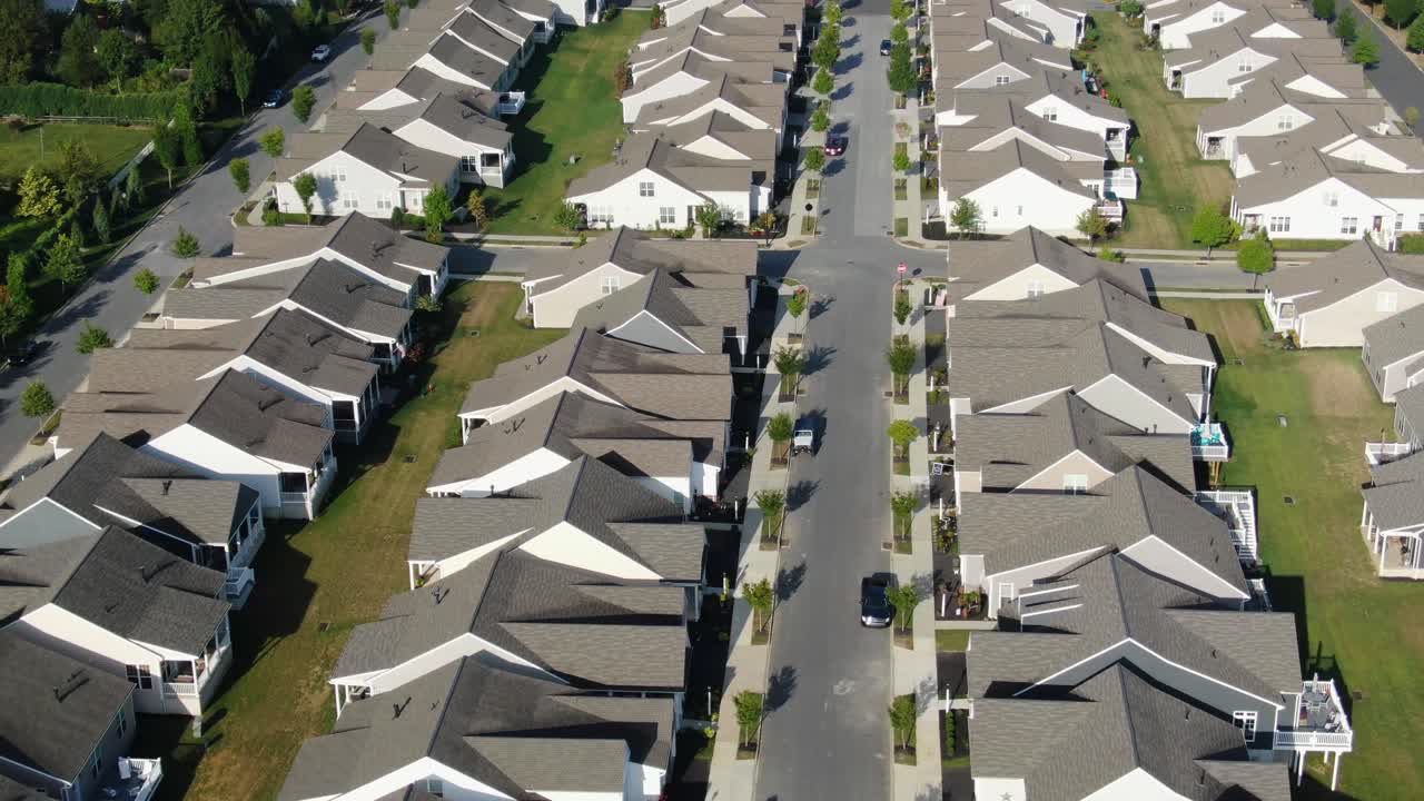 el camión aéreo a la derecha revela cientos de casas prefabricadas casi idénticas en los suburbios de estados unidos.
