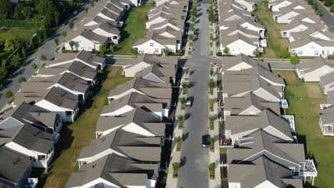 aerial truck right reveals hundreds of nearly identical cookie-cutter homes in suburban america