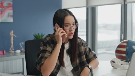 nervous manager talking cellphone office closeup. stressed woman gesturing hands