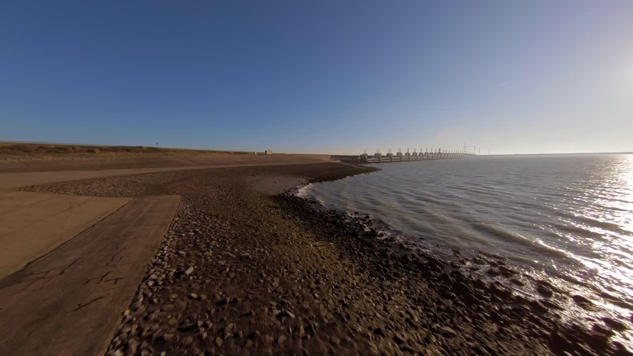 Fast moving above a dyke towards the storm surge barrier bridge in the Netherlands