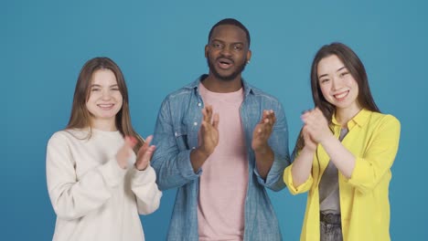 three friends of different races applaud, congratulate. different race and ethnicity concept.