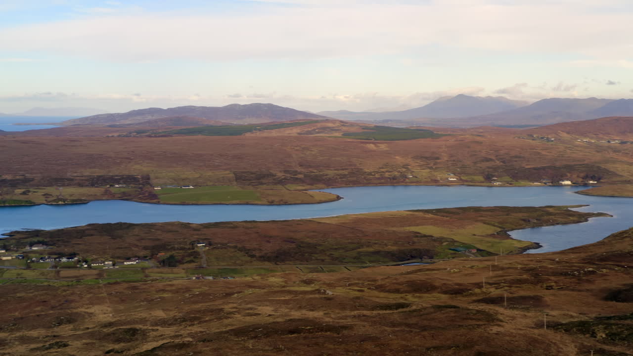 Aerial pan of a Clifden Bay inlet with the Twelve Bens in the background. Connemara landscape