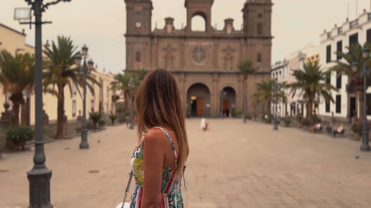 Tourist admiring Las Palmas Cathedral in Santa Ana Square, Gran Canaria