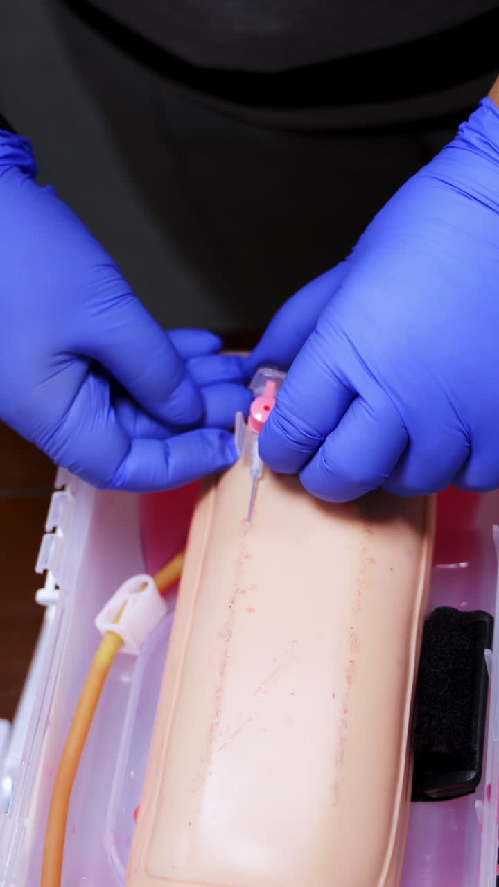 Practical procedure with an injection. Student practices to prick injection into dummy's hand in the training center. Top view. Close-up. Vertical video
