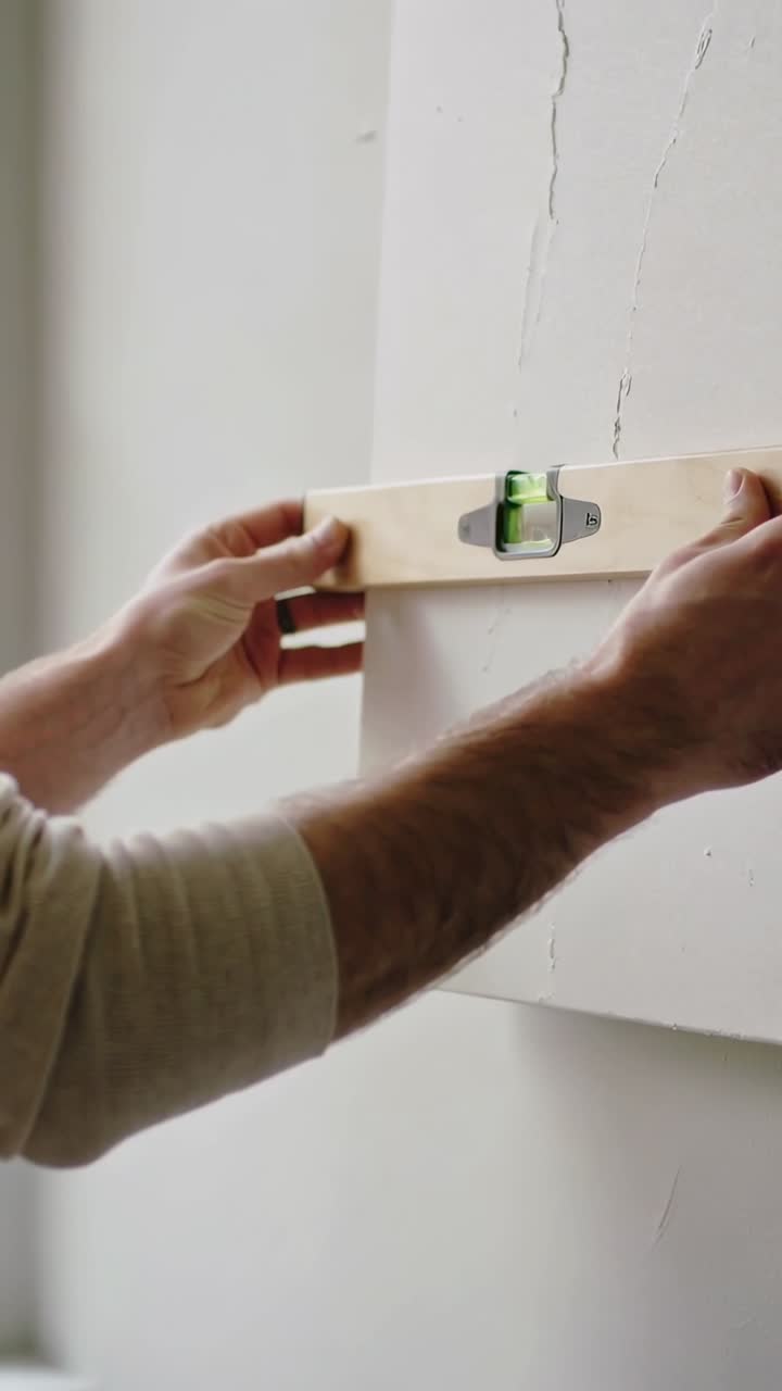 Close Up of Hands Using a Spirit Level to Check Alignment