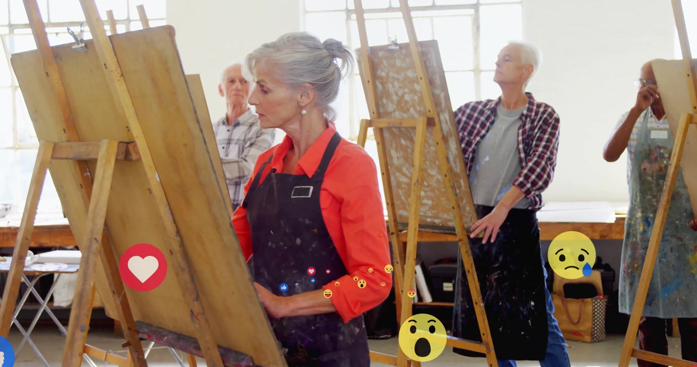 senior painter starting stroke at easel in art studio sparking reaction icons drifting upward
