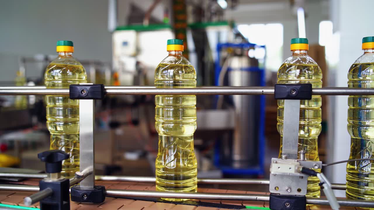 Sunflower oil in bottles. Sunflower oil in the bottle moving on production line
