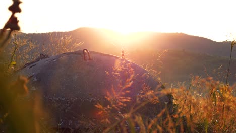 albania, close-up of a concrete bunker amidst mountains, against the backdrop of the rising sun