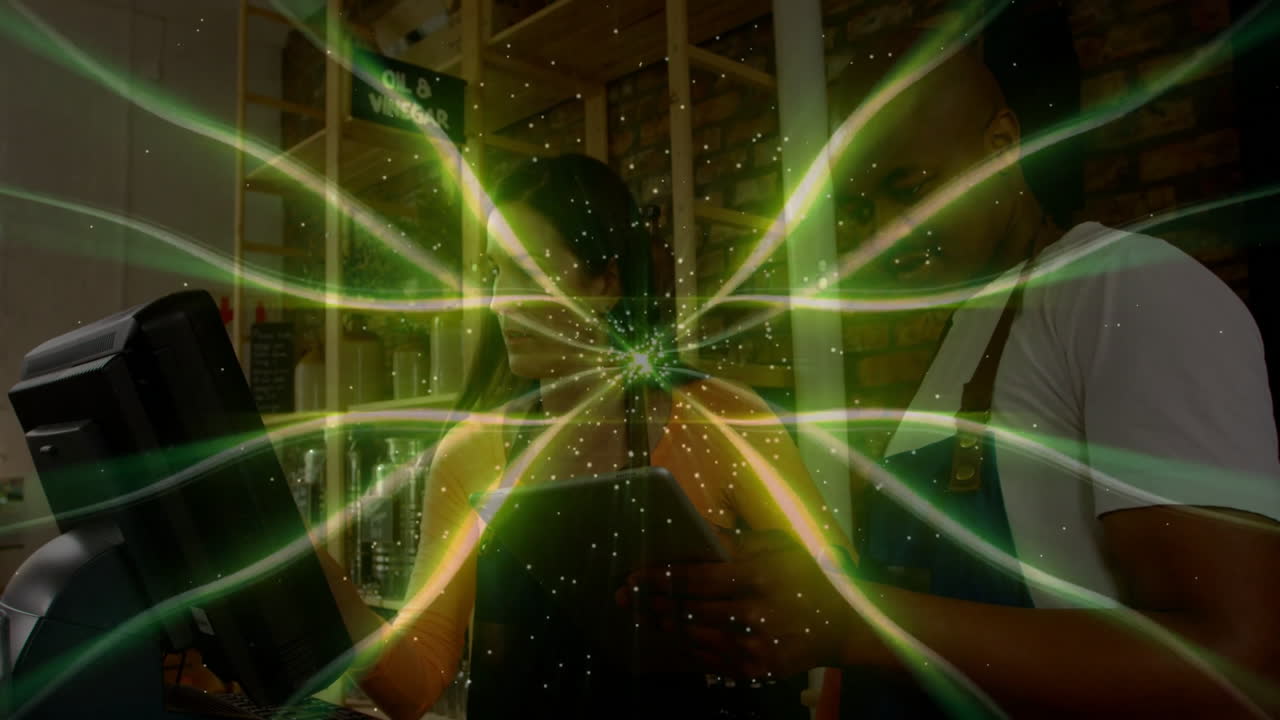 Green energy wave animation over people working at store counter