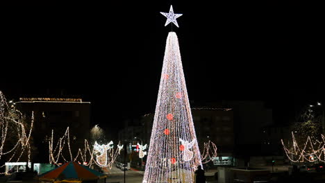 starry christmas tree lights up night town square