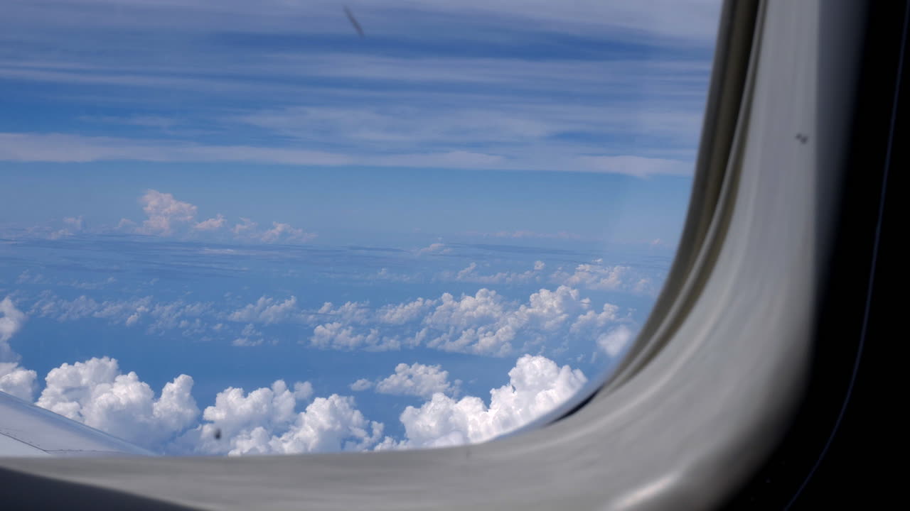 Panorama wide shot of plane flight above cloudscape and blue sky