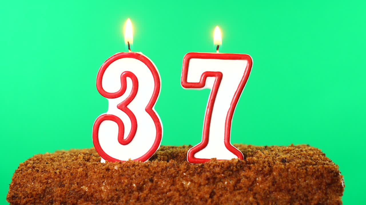 Cake with the number 37 lighted candle. Chroma key. Green Screen. Isolated