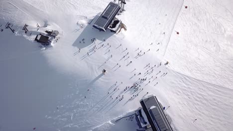 aerial view of ski resort with people snowboarding down the hill