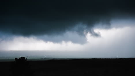 dark clouds sweeping across open country side stormy dramatic scene