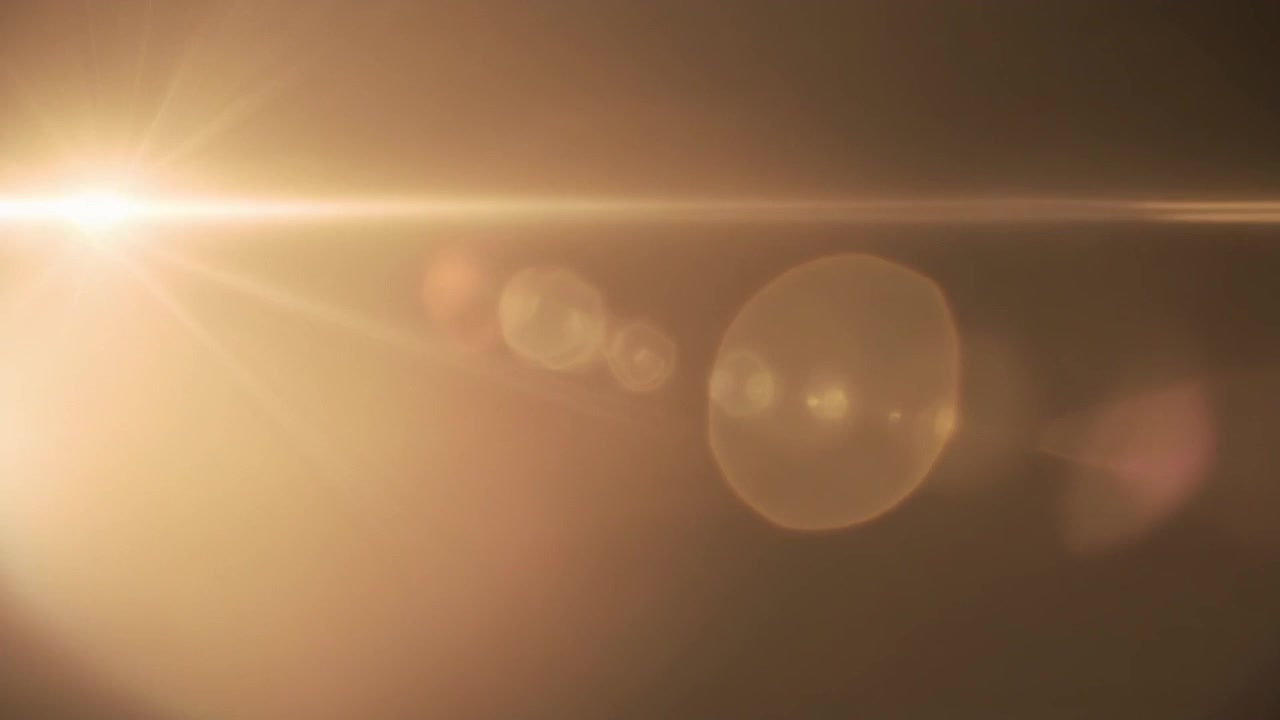 Effetto Flare Lente Dorato su Sfondo Scuro
