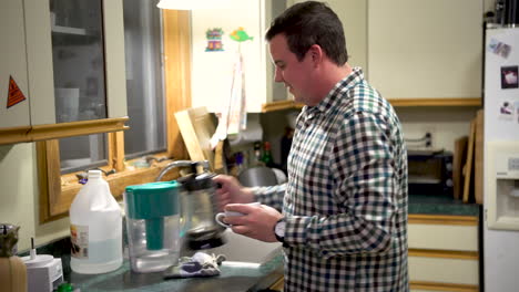 White-male-pours-himself-a-warm-cup-of-coffee