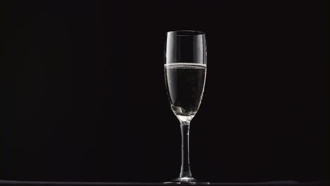 champagne glasses with champagne rotating on a black background champagne glasses with champagne rotating on a black background concept celebrating time new years eve valentines day