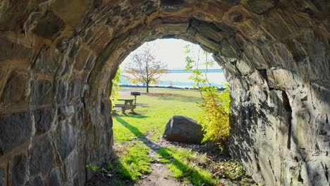 a walk through an old stone tunnel on a sunny day in a park in new jersey