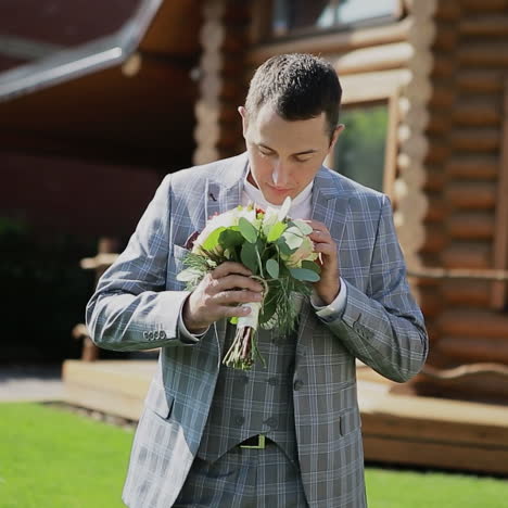 young man with flowers. groom holding wedding bouquet. square video