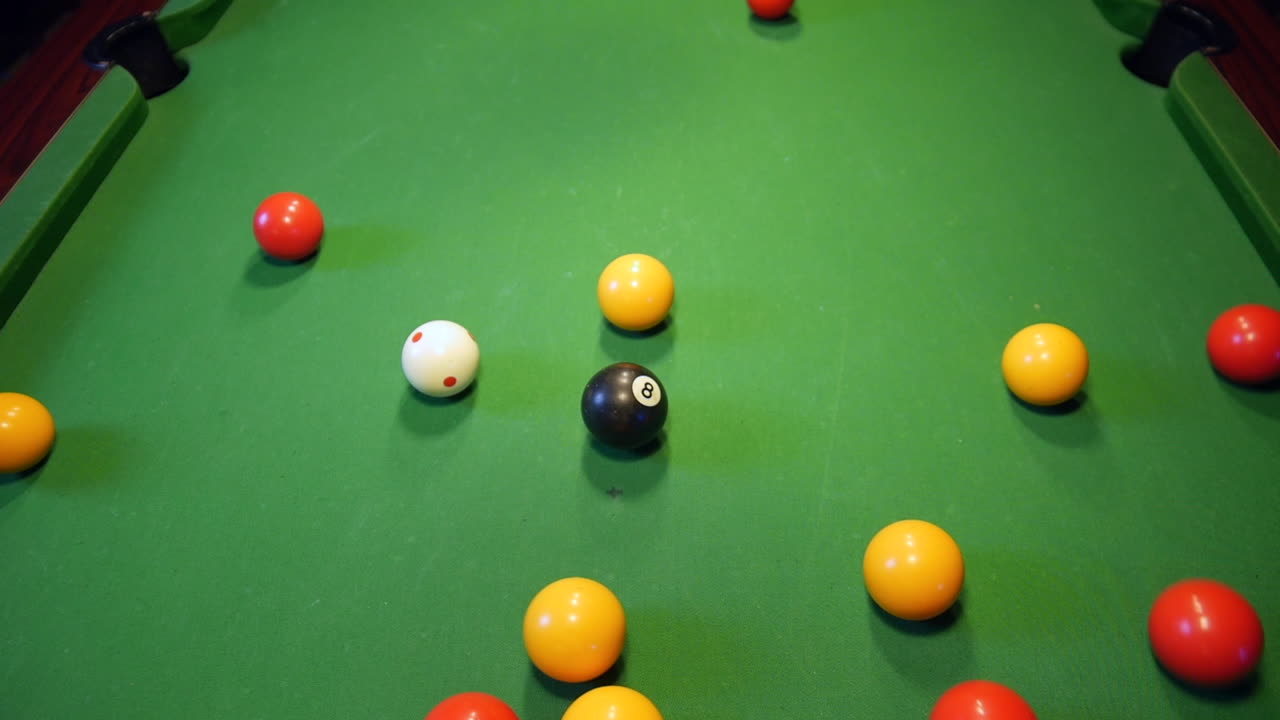 Pool balls racked in a triangle are struck by the white ball