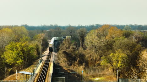 train moving through west memphis delta regional river park with autumn trees