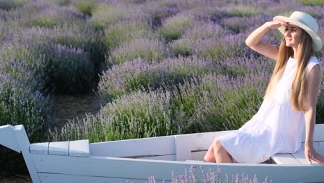 Beautiful Lady in White Style Posing in Lavender Flowers and Enjoying Sun and Beauty Beautiful Lady in White Style Posing in Lavender Flowers and Enjoying Sun and Beauty Photo Session in a Lavender Field Decor for a Photo Shoot
