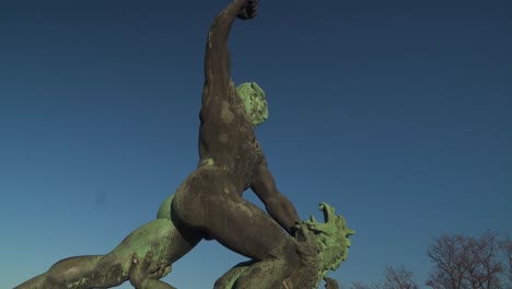 화창한 날 헝가리 부다페스트 겔러트 언덕 꼭대기에서 머리가 세 개 달린 용과 싸우는 헝가리 전사의 아름다운 동상 - 위로 기울어지는 총