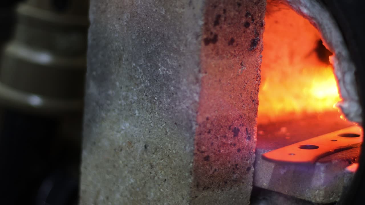 Forging oven with door open with flames and heat going out with cbeautiful red and yellow colors in blurred background