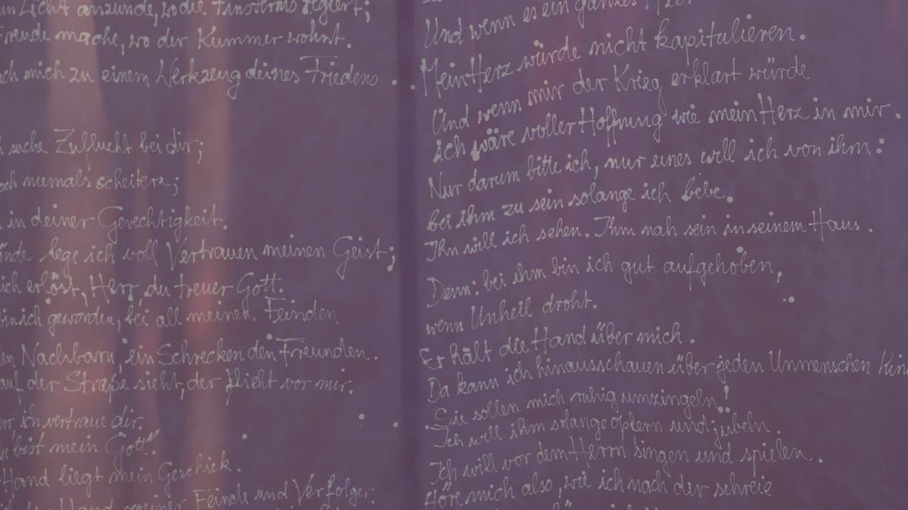 A purple banner with a prayer waving lightly in the wind