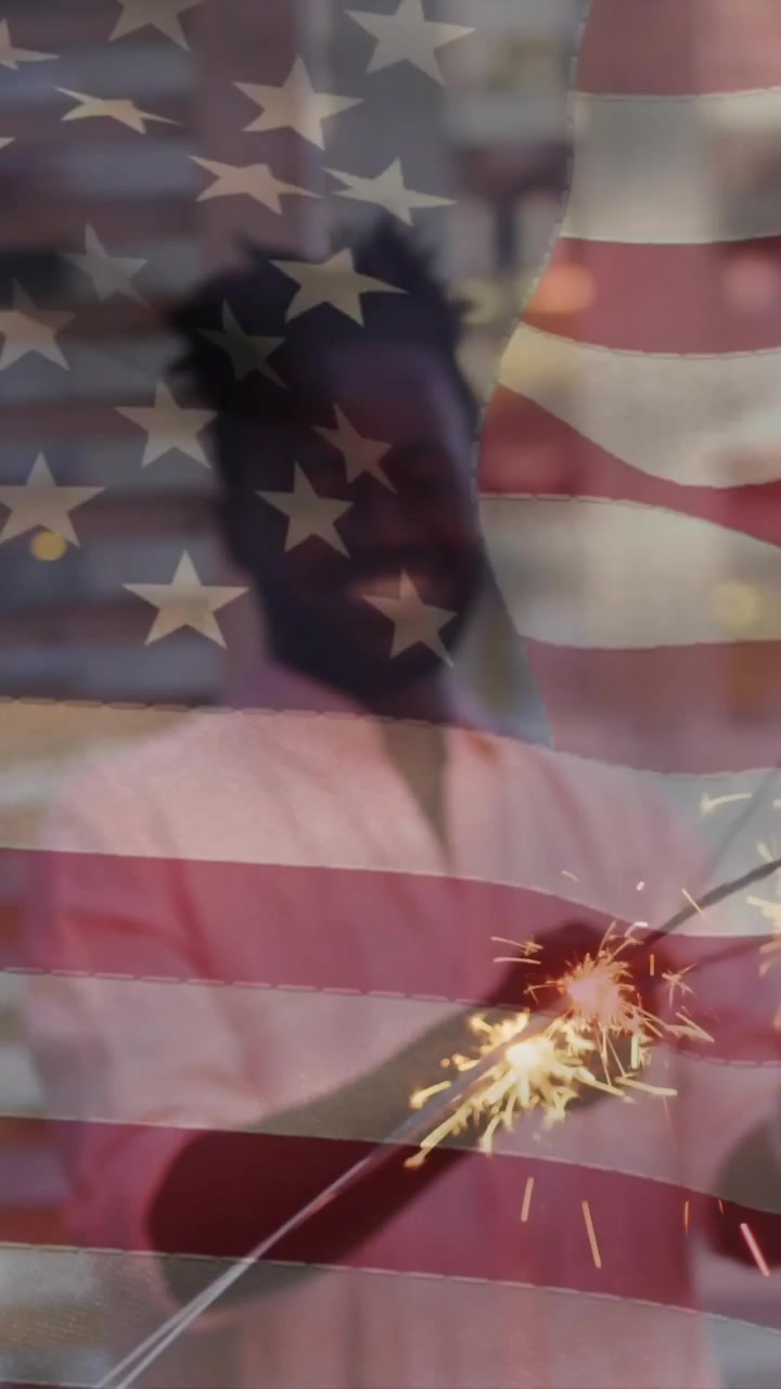 Holding sparklers, person celebrating with American flag overlay in festive animation