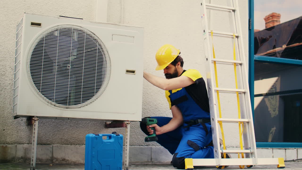 Worker works on air conditioner