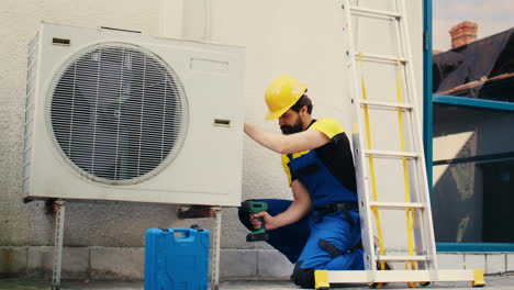 worker works on air conditioner