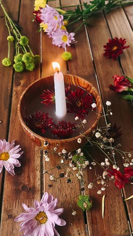 candles and flowers on wooden table