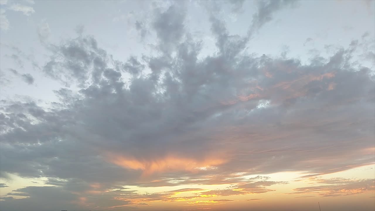 Stunning sunrise timelapse with golden sun emerging through drifting clouds. Perfect for nature intros, transitions, weather, meditation, documentaries or cinematic mood scenes.