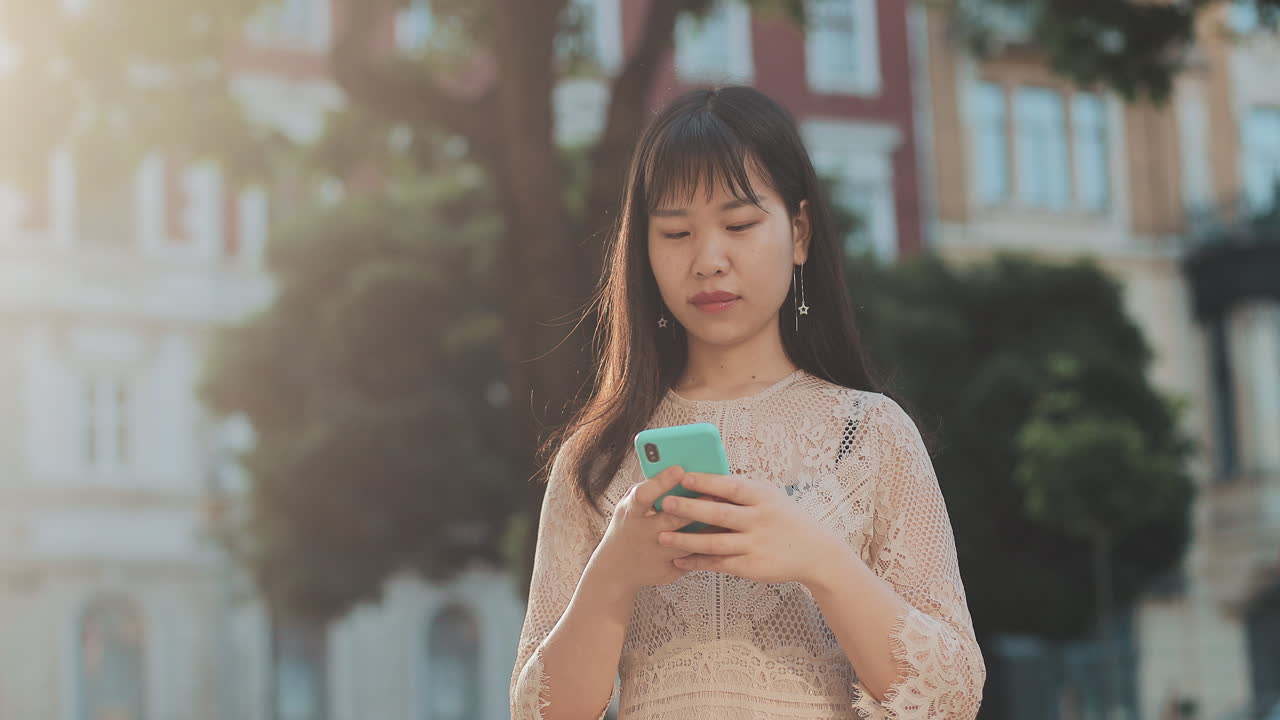 Woman using phone in city setting