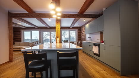 home interior of a kitchen with natural wooden floor and beam with kitchen set