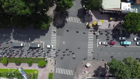 aerial birds eye view over road intersection in ho chi minh city during rush hour