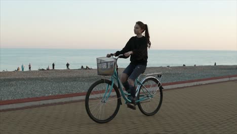 woman riding a bicycle on a beach