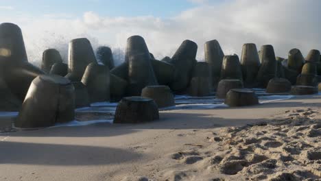 Static-slow-motion-shot-of-waves-hitting-the-tetrapods-located-at-the-beach-of-Hörnum-at-the-island-of-Sylt