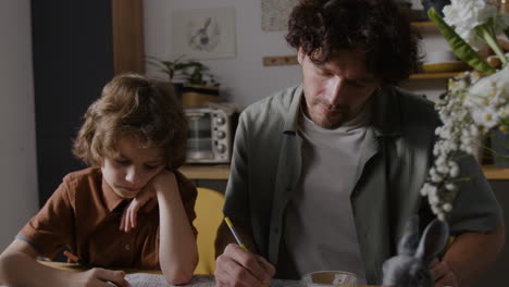 father and son coloring together