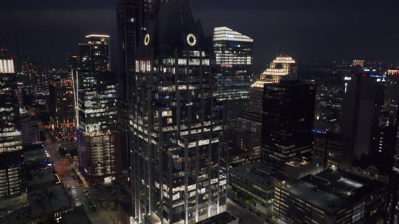 Nighttime cityscape with illuminated skyscrapers