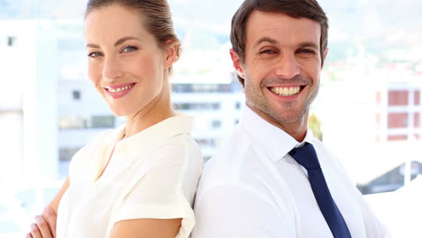 happy business team standing back-to-back