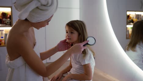 Child-and-mama-brushing-hair-of-young-kid-in-house-and-getting-ready-for-the-day