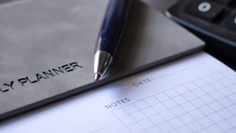 close-up of a daily planner with pen