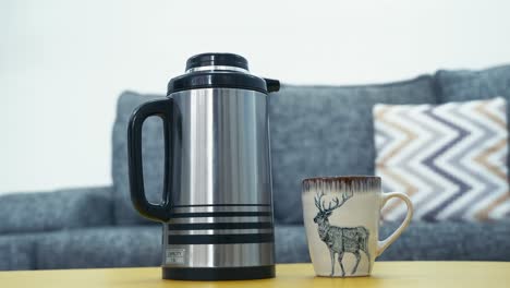 vacuum flask and coffee mug on center table in the living room