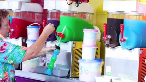 person preparing multiple slushie drinks in sequence