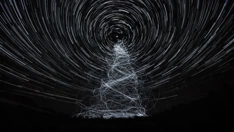 a beautiful display of star trails forming an ethereal tree shape illuminating the night sky in a wonderfully captivating light show with spiraling patterns