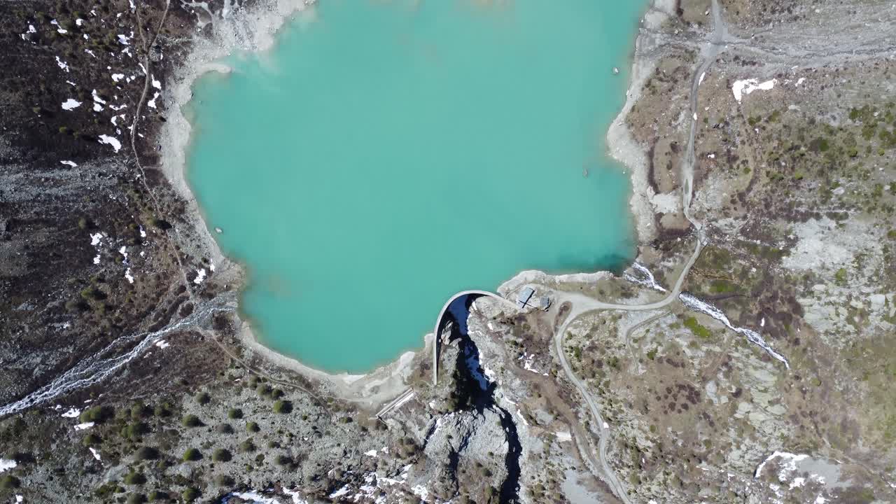 turquoise mountain lake in the middle of the Swiss Alps, drone shot from above (lake turtmann)