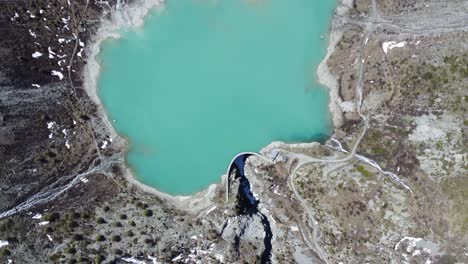 turquoise mountain lake in the middle of the swiss alps, drone shot from above (lake turtmann)